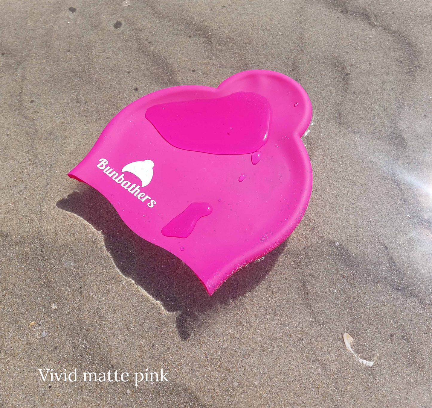 Bright pink swim cap designed to keep a ponytail or bun dry | Bunbathers