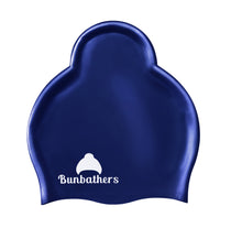 Load image into Gallery viewer, Shiny navy Bunbathers ponytail swim cap to keep long hair dry
